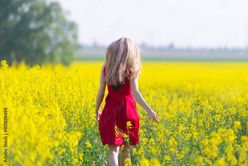 The girl in red is on the rape field. The girl in red is on the rape field.