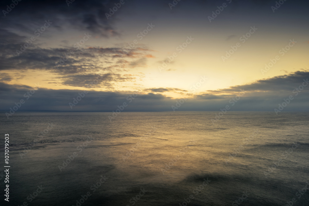 Beautiful vibrant sunrise landscape over calm sea