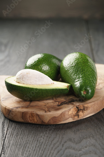 ripe green avocados on wood table, selective focus
