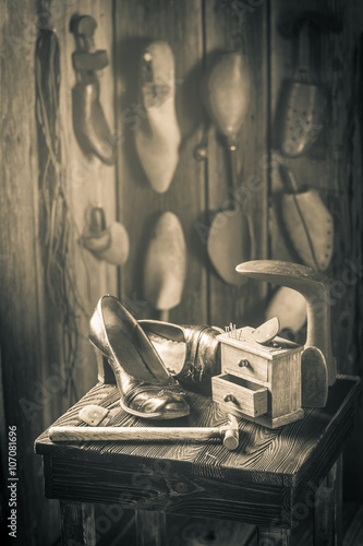 Old cobbler workplace with brush and shoes