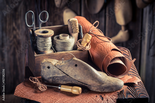 Small shoemaker workshop with shoes, laces and tools