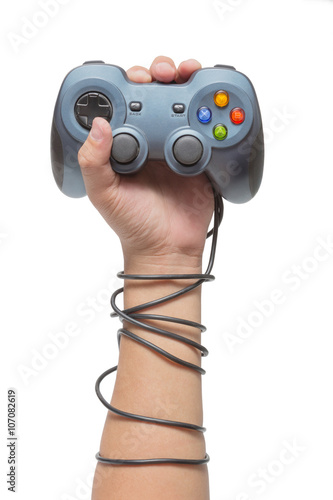 hand holding game controller and tied up with cables