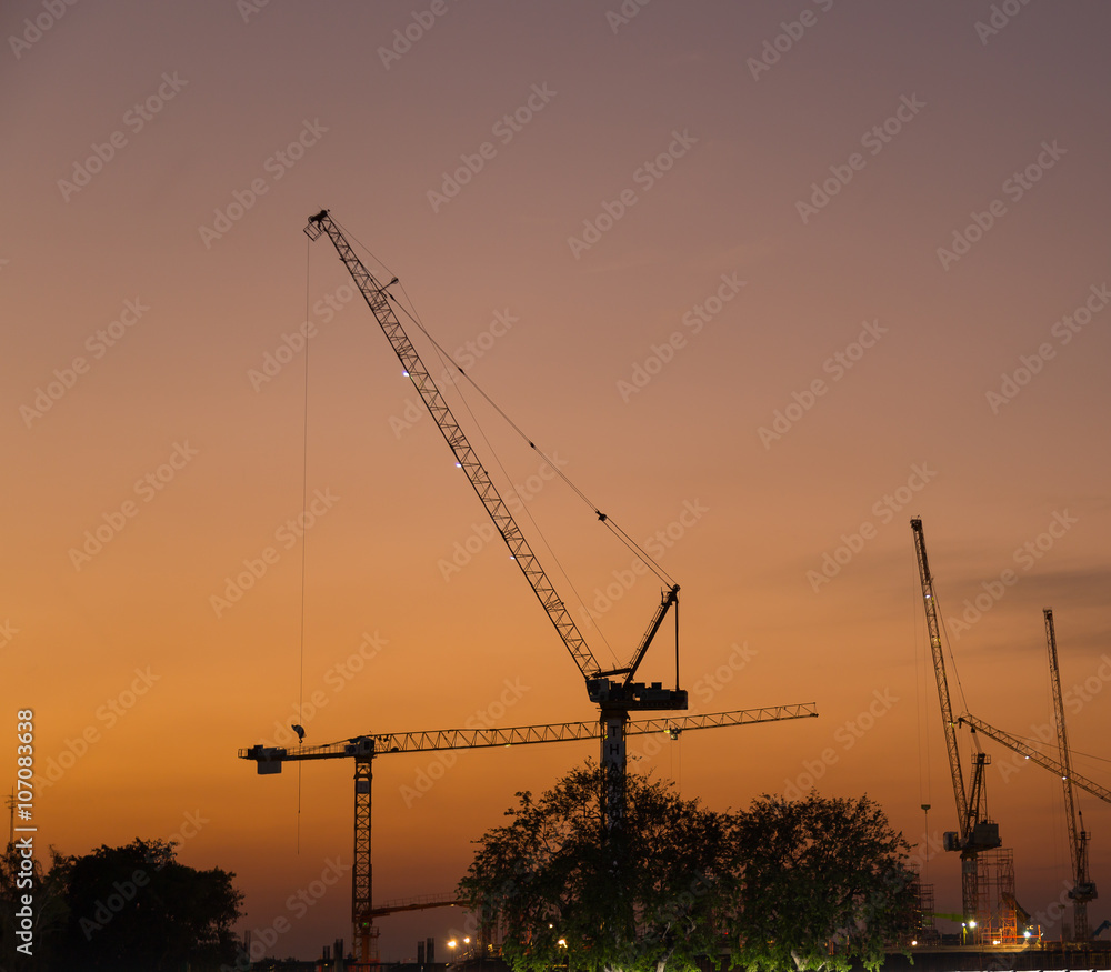 Construction cranes in evening