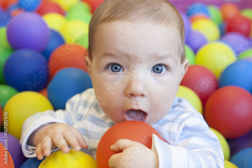 baby boy playing in the playground balls pool