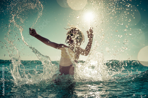 Happy child playing in the sea