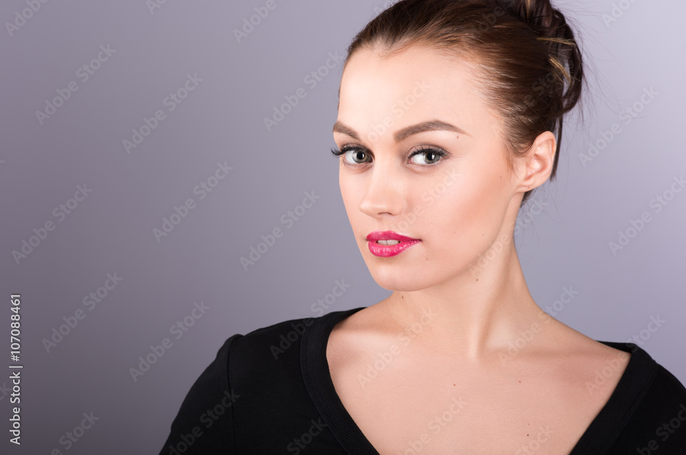 Portrait of attractive brunette in a black dress on a neutral gr Portrait of attractive brunette in a black dress on a neutral gr