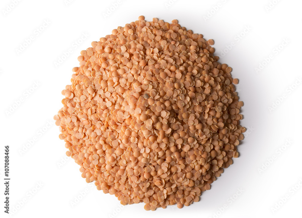 A pile of red lentils isolated on white with a slight shadow. A pile of red lentils isolated on white with a slight shadow.
