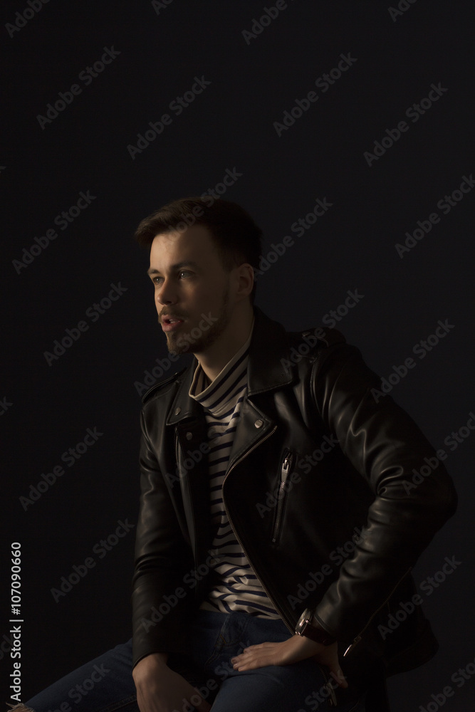 Young man in a black leather jacket