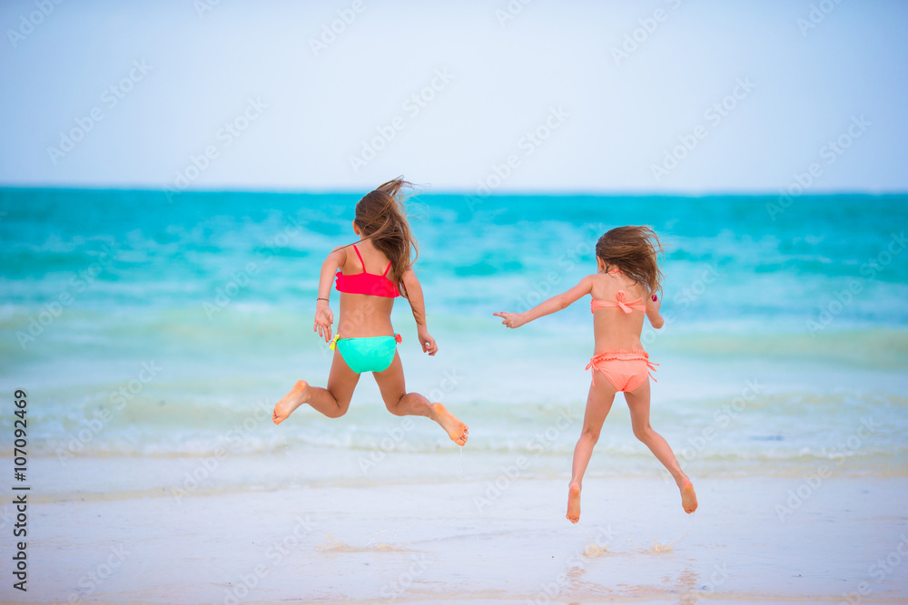 Kids having fun at tropical beach during summer vacation Kids having fun at tropical beach during summer vacation
