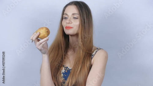 Wallpaper Mural Beautiful young girl eating a pear in studio. Young healthy young woman holding up a fresh pear and eating. Concept of healthy eating, dieting and nutrition. Torontodigital.ca