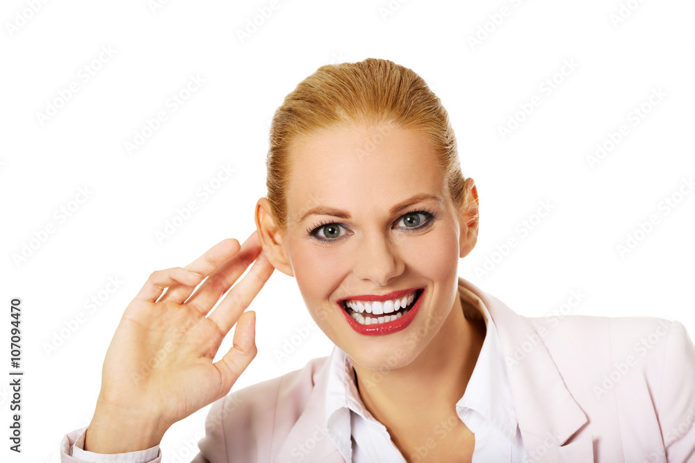 Young woman overhears conversation and laughing Young woman overhears conversation and laughing
