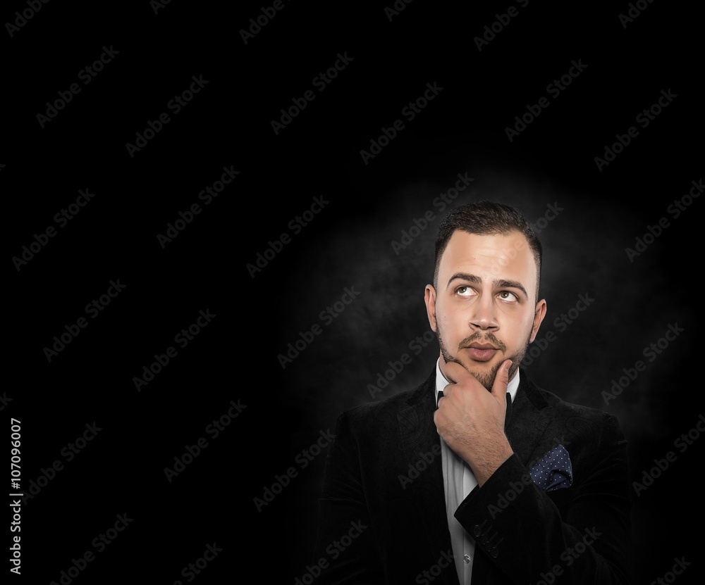 Man in black suit thinking or dreaming. Man in black suit thinking or dreaming.