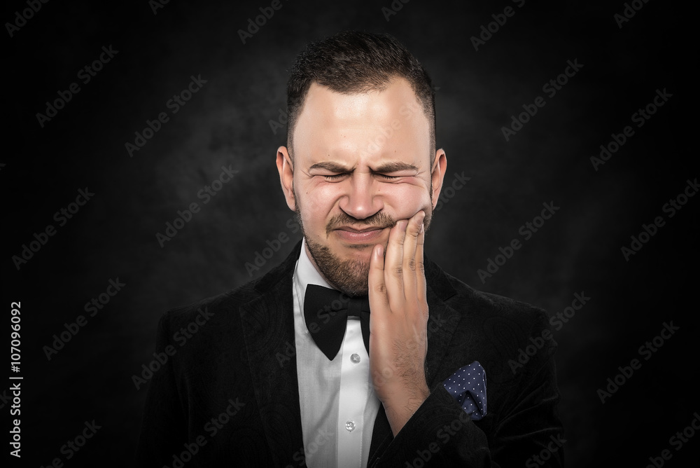 Young man feels toothache Young man feels toothache