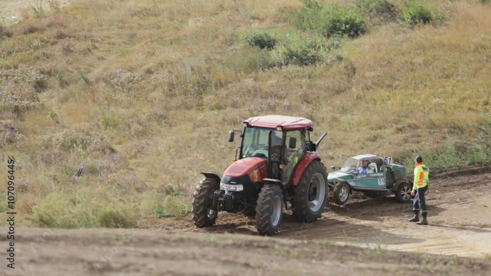 Rural equipment towing car came down the road Rural equipment towing car came down the road