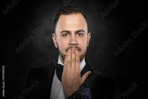 Funny man hand covering mouth.