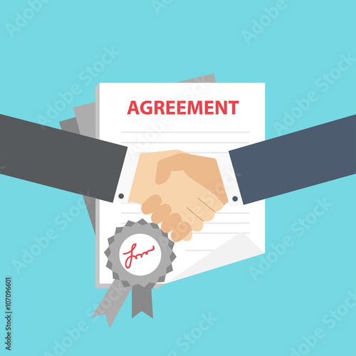 Businessman handshake on contract paper after agreement