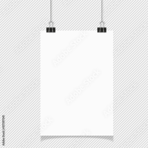 Blank white page hanging against grey background
