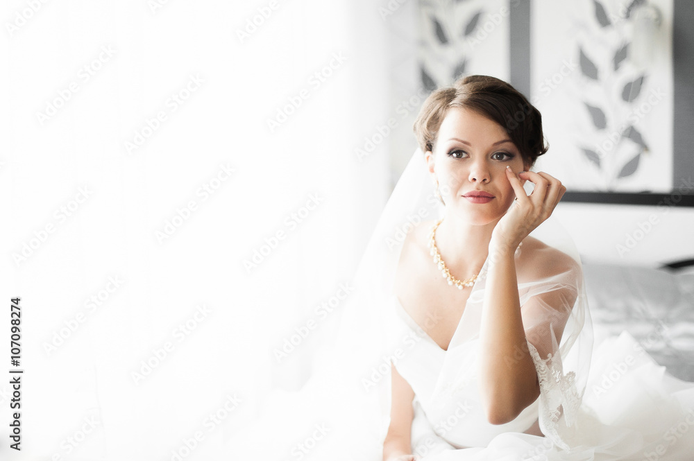Portrait of beautiful bride with fashion veil posing at home at Portrait of beautiful bride with fashion veil posing at home at