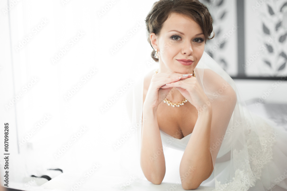 Portrait of beautiful bride with fashion veil posing at home at Portrait of beautiful bride with fashion veil posing at home at