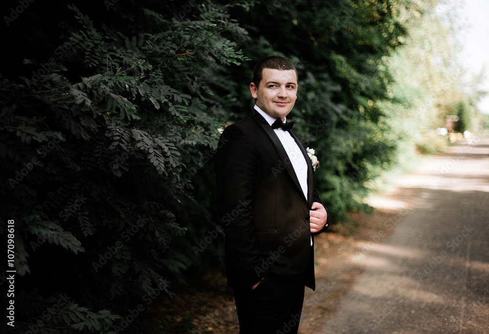 wedding day. Groom is staying and waking wearing black classic c wedding day. Groom is staying and waking wearing black classic c