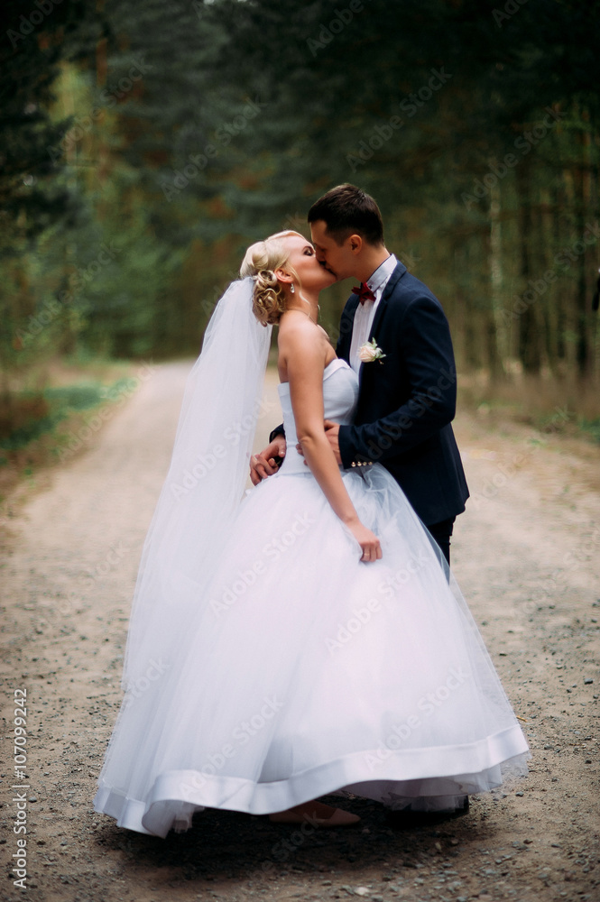 Bride and groom at wedding Day hugging Outdoors on spring nature Bride and groom at wedding Day hugging Outdoors on spring nature