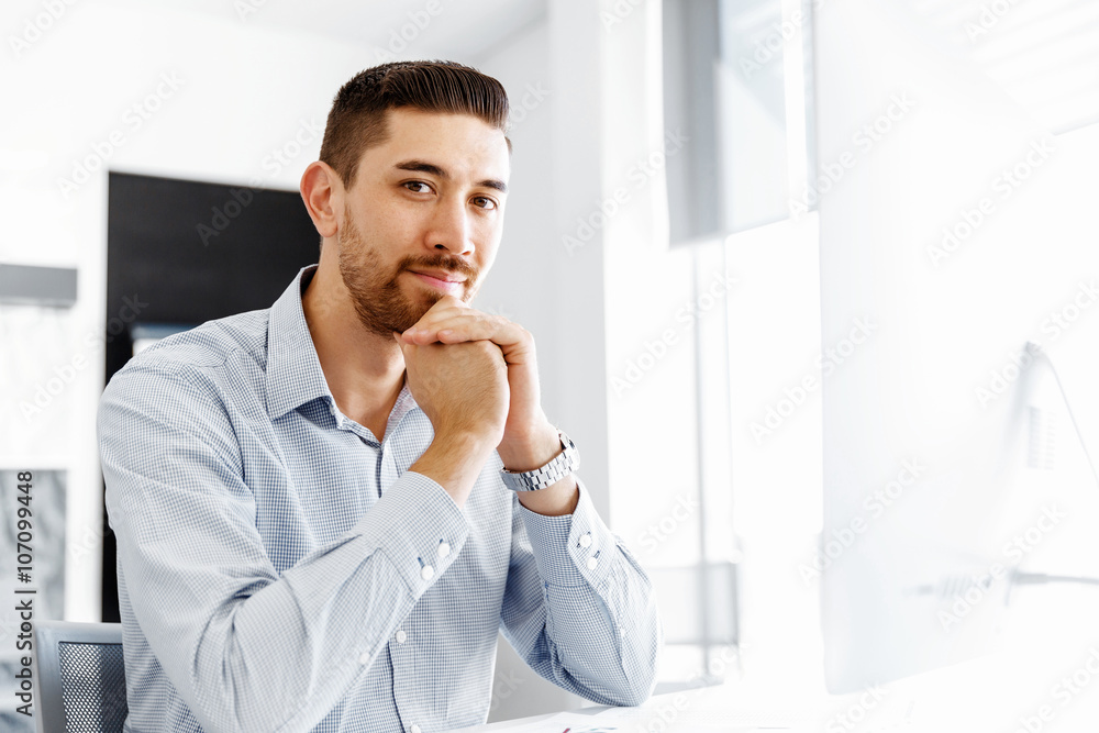 Male office worker sitting at desk Male office worker sitting at desk
