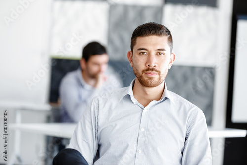 Attractive office worker sitting at desk