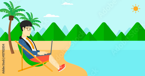 Businessman sitting in chaise lounge with laptop.