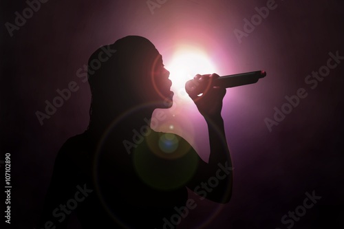 Women singing under spotlight