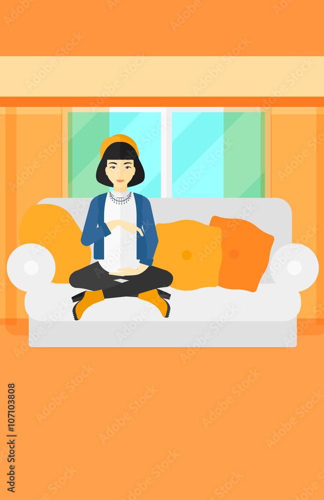 Pregnant woman sitting on sofa.