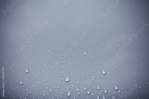 Dops of water on a color background. Blue. Toned