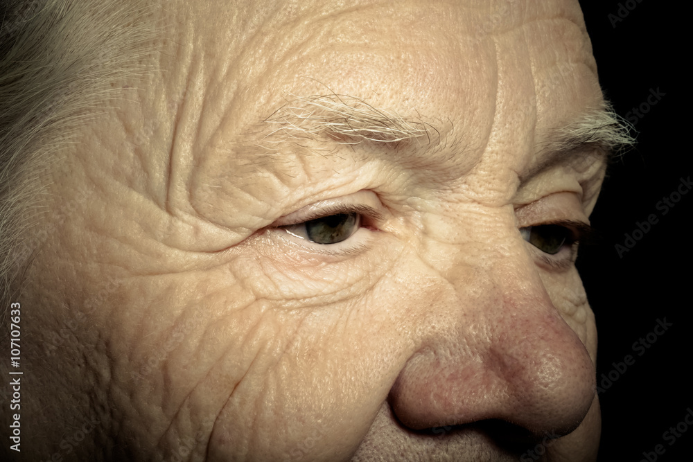 Portrait of elderly woman on dark background. Toned Portrait of elderly woman on dark background. Toned