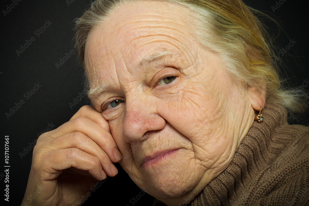 Portrait of elderly woman on dark background. Toned Portrait of elderly woman on dark background. Toned