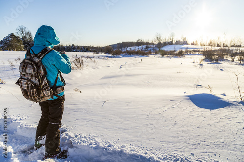 Woman Snowshoeing in Winter time Landscape