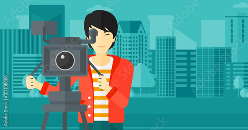 Cameraman with movie camera on a tripod.
