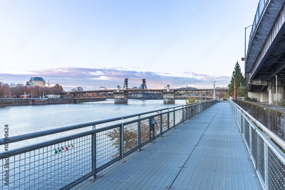 empty footpath near river and bridge and skyline in portland