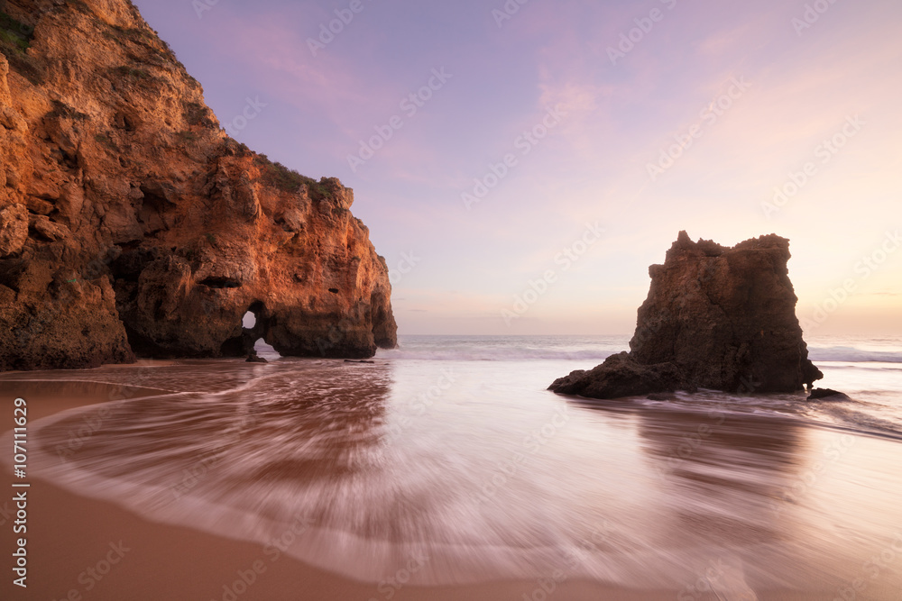 Sunset at rocky coastline of Atlantic ocean