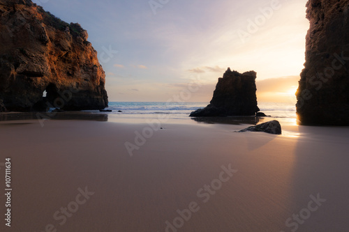 Sunset at rocky coastline of Atlantic ocean