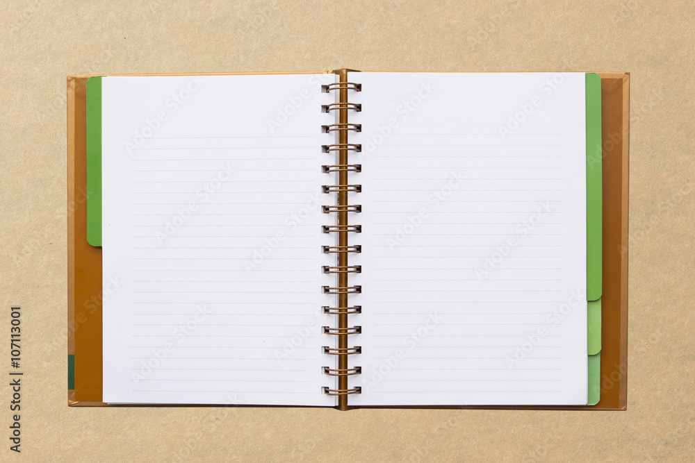 Open notebook with lined pages isolated on board background. Open notebook with lined pages isolated on board background.