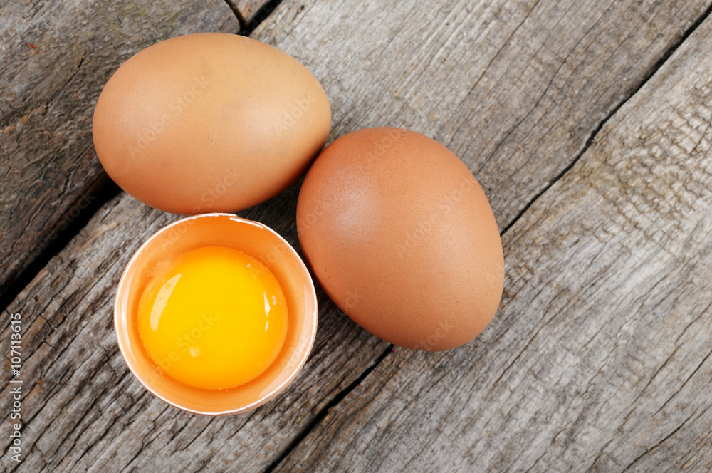 Whole and broken raw brown eggs Whole and broken raw brown eggs