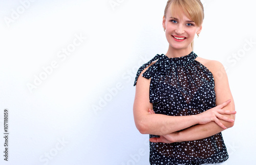 Portrait of an attractive young woman standing with crossed arms