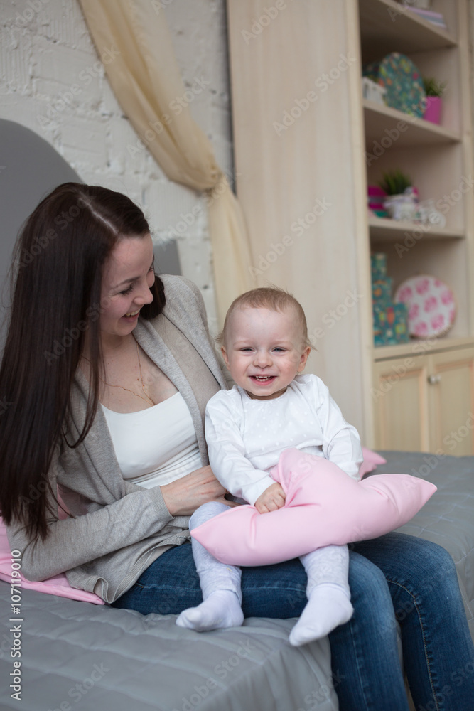Funny playful mum with baby toddler at home Funny playful mum with baby toddler at home