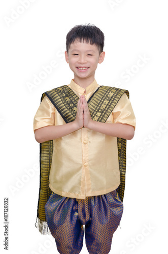 Young boy in Thai traditional dress smiling and do gesture welco photo