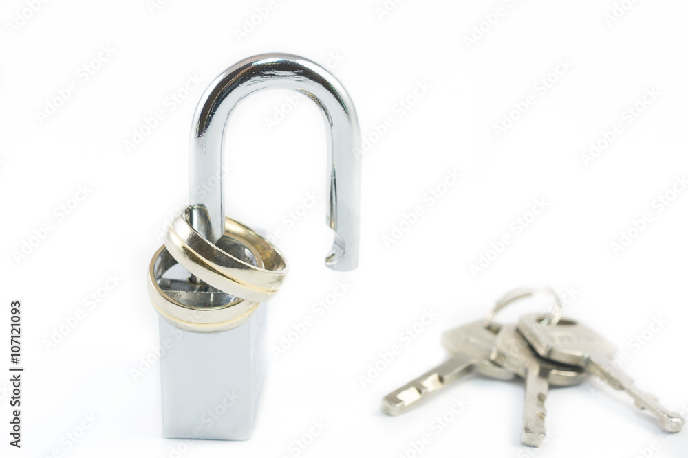 Wedding rings on opened shiny padlock and keys on white background. Concept for marriage problems Wedding rings on opened shiny padlock and keys on white background. Concept for marriage problems
