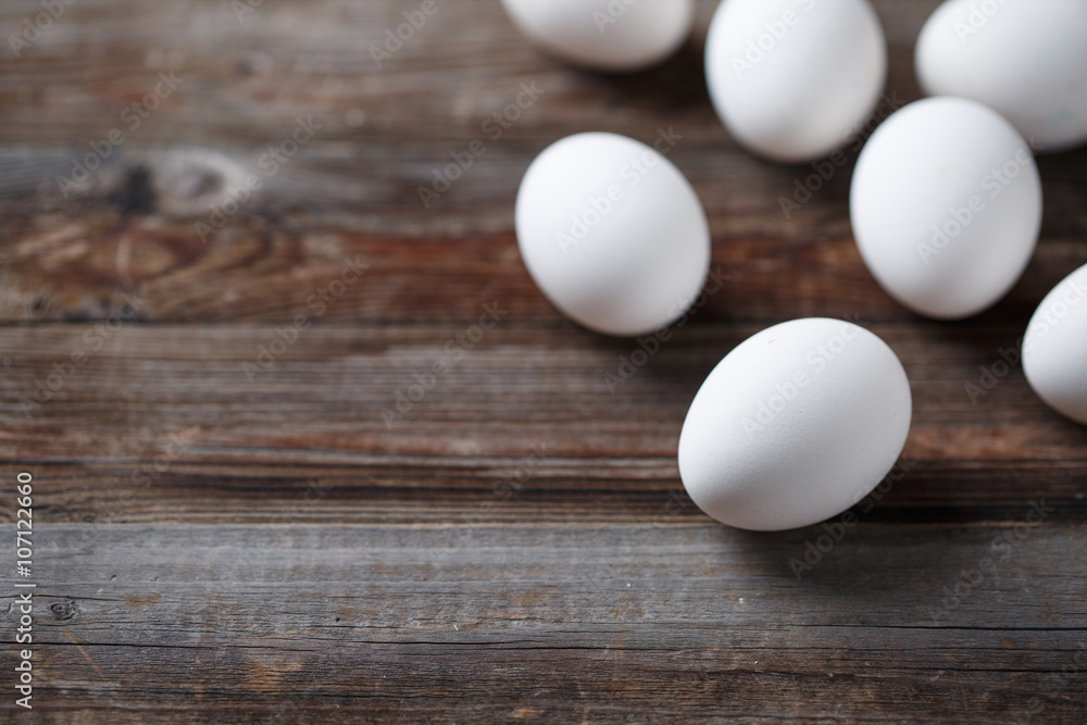 White eggs on the old wood table White eggs on the old wood table