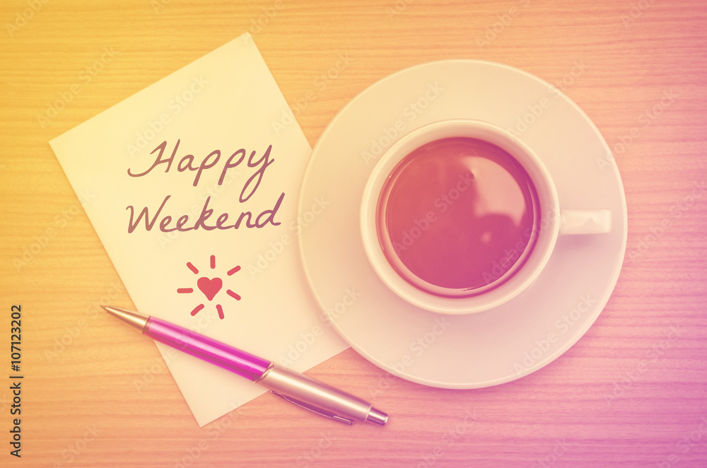 Happy weekend with coffee cup on table with vintage filter Happy weekend with coffee cup on table with vintage filter