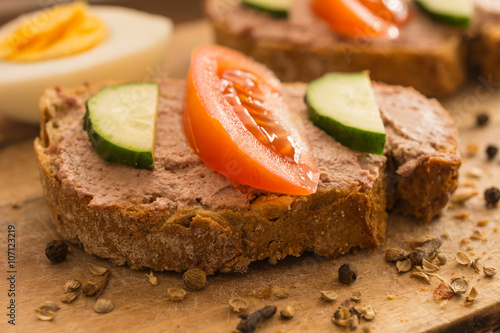 Sandwiches with pork chicken liver pate on rustic wooden table