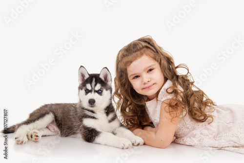 Little girl with puppy huskie