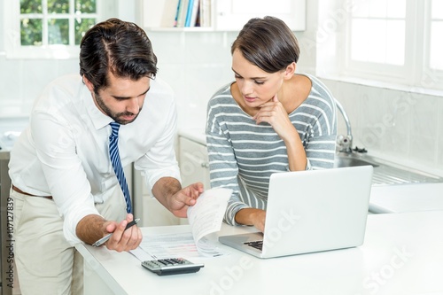 Businessman with woman looking at document
