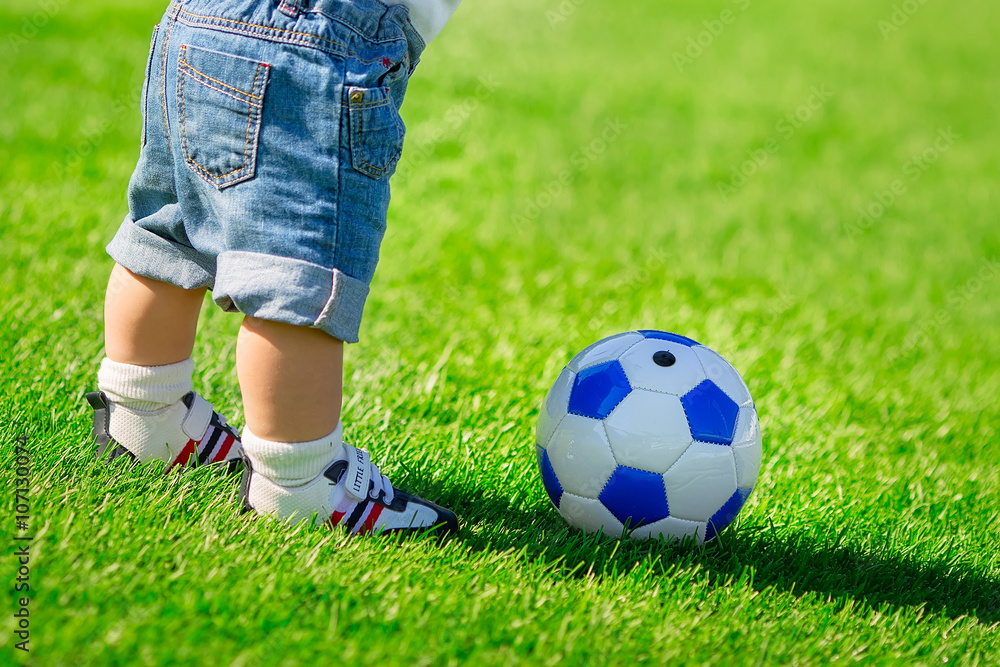 boy with a soccer ball on green grass boy with a soccer ball on green grass
